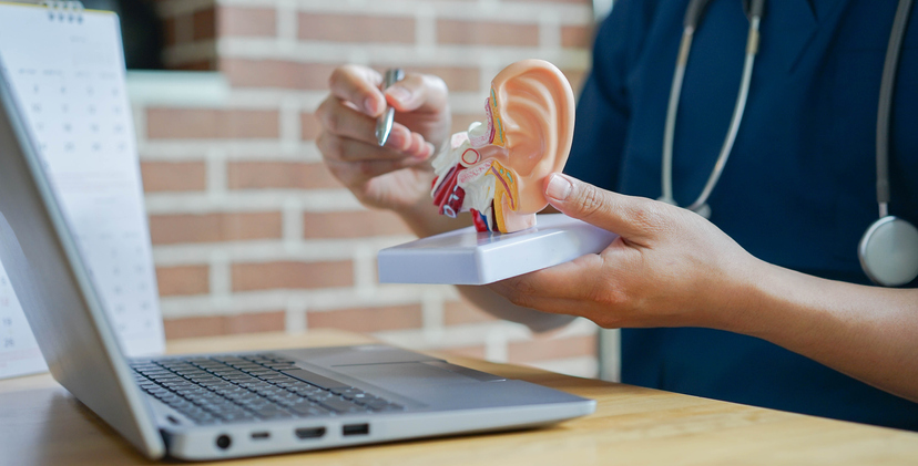 close up professional audiologist explain and diagnose to patient by pointing on human ear anatomy about eardrum symptom for treatment and heal concept